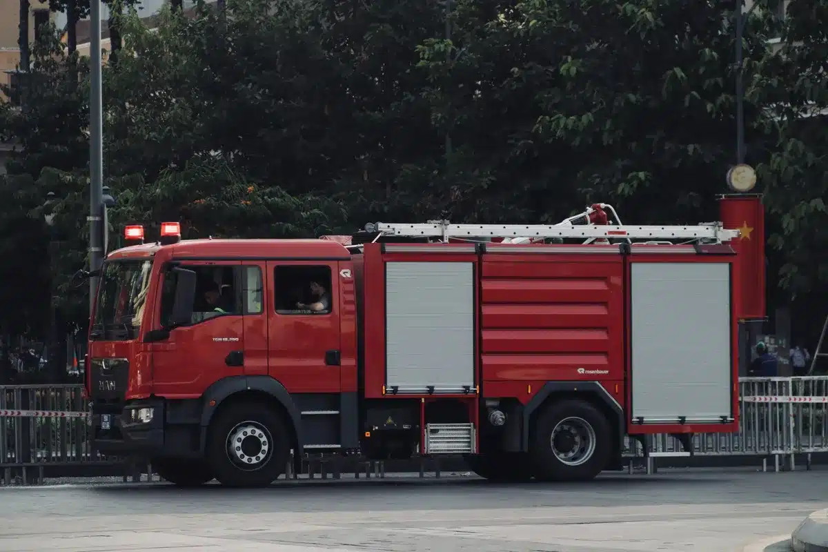 Emergency vehicles and firefighters at a motorway incident scene