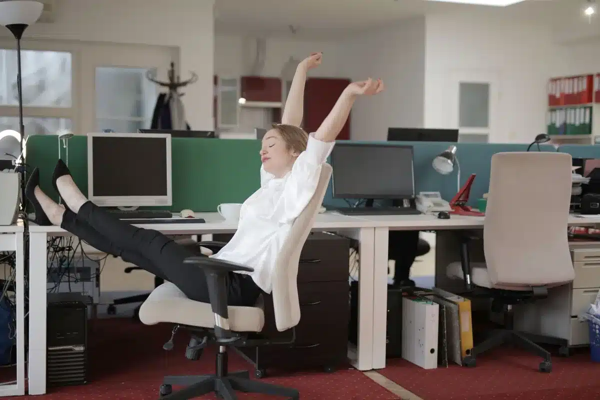 Person stretching away from a screen during a viewing break