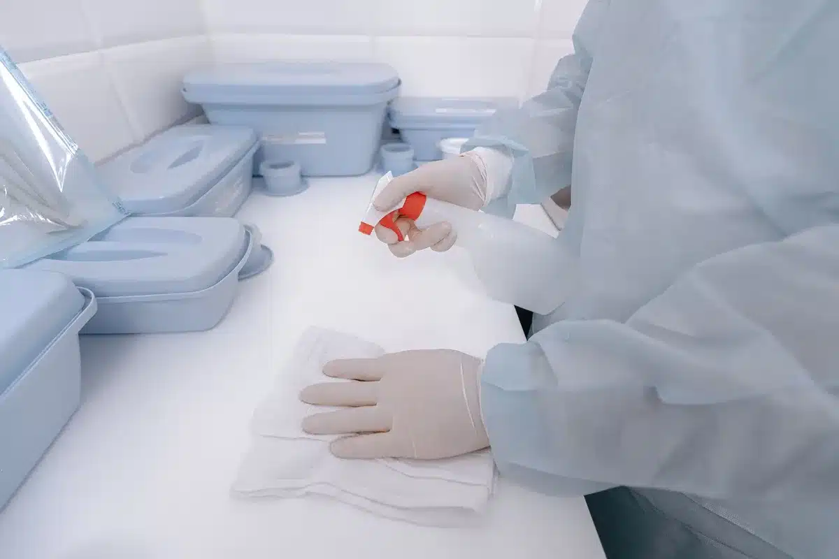 Hospital staff using EPA-registered disinfectant to clean medical equipment and surfaces