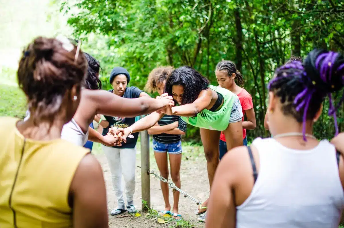 Young women participating in a group leadership activity, building confidence together.