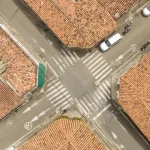 Autonomous taxi navigating a busy London street with pedestrians and cyclists nearby
