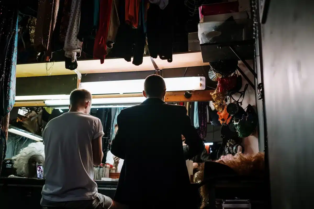 Designer working with performer on custom stage costume fitting