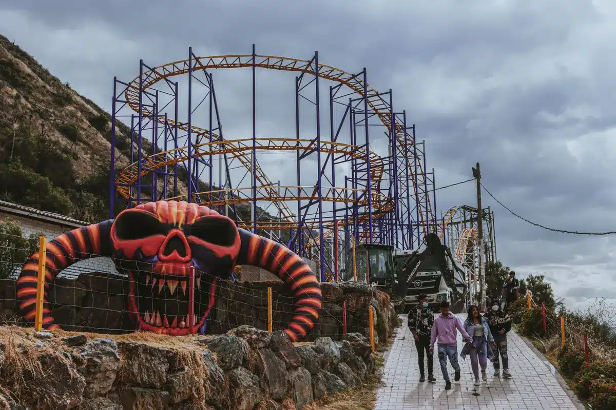 Families enjoying rides and attractions at a mountain theme park