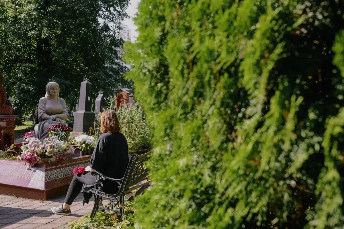 Peaceful garden space with flowers and memorial elements in a public park setting