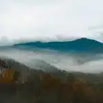 Aerial view of a mountain theme park with roller coasters and visitor attractions nestled in Tennessee foothills