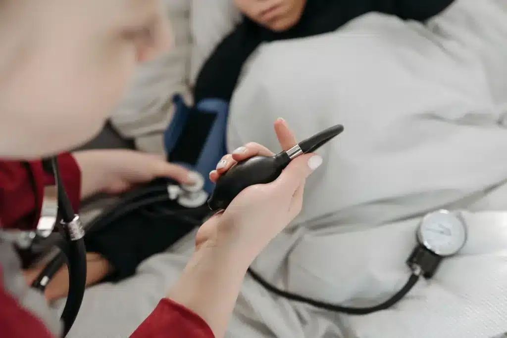 Woman checking blood pressure at home using a digital monitor on her wrist