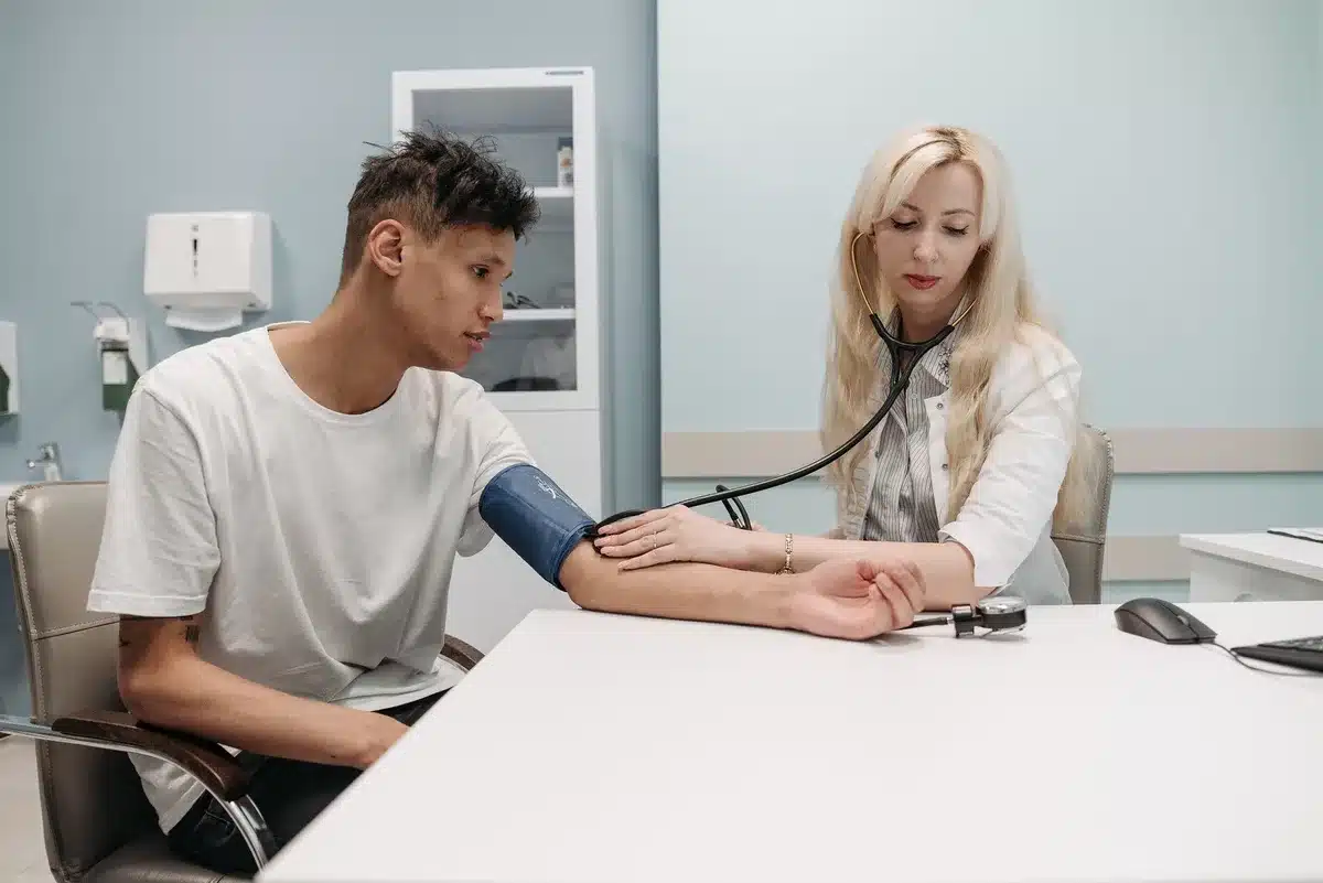 Healthcare provider discussing medication side effects with patient in consultation