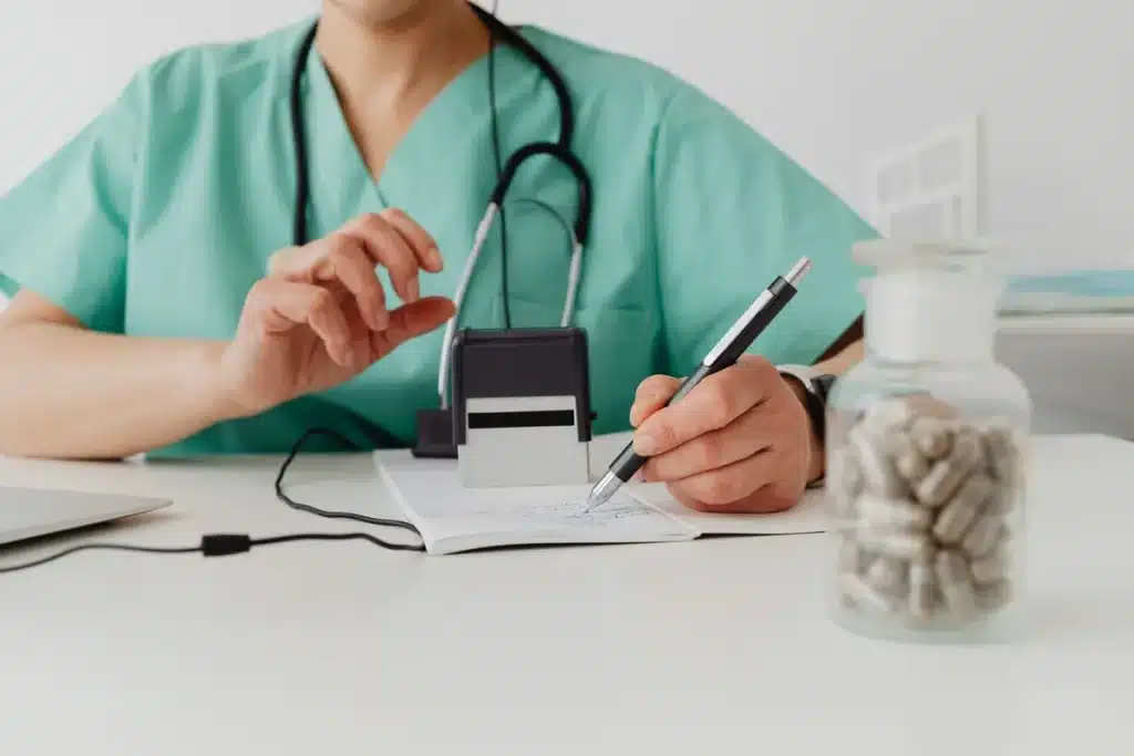 Prescription medication bottle and paperwork on a clinic desk