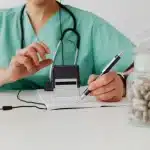 Prescription medication bottle and paperwork on a clinic desk