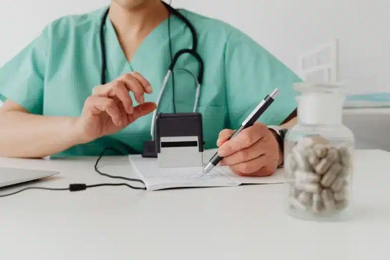 Prescription medication bottle and paperwork on a clinic desk