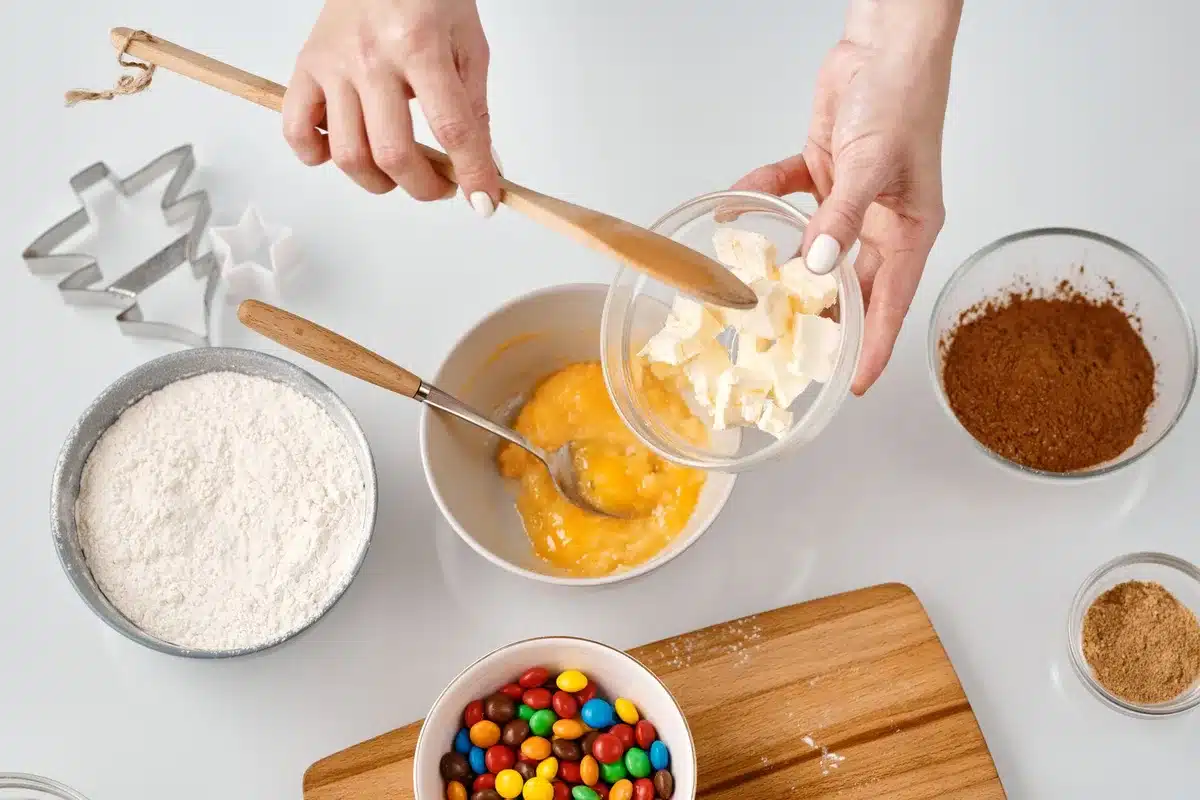 Ingredients for chocolate brownies: butter, sugar, eggs, flour, cocoa powder, and milk chocolate bars arranged on a kitc
