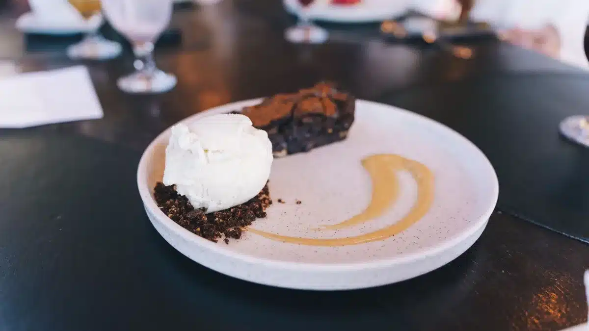 Warm fudgy brownie square topped with a scoop of vanilla ice cream