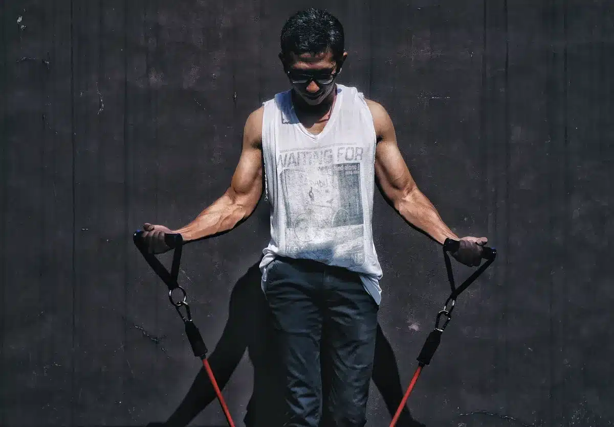 Man performing resistance training or strength exercise in a gym setting