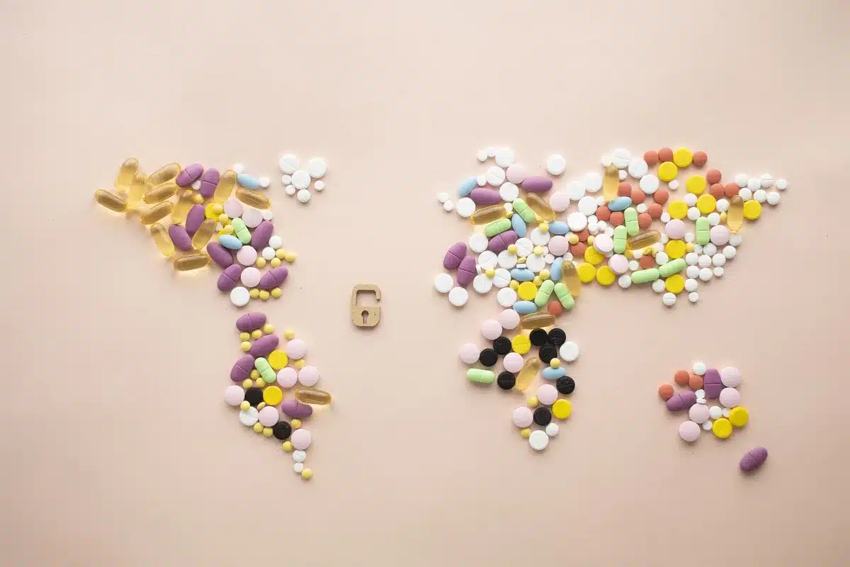 A pharmacy counter with diverse medications and healthcare workers, representing worldwide implementation challenges