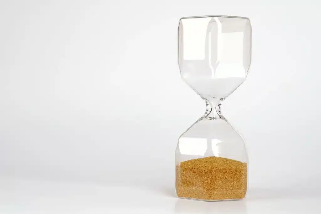 Hourglass with sand flowing, symbolizing the finite limits of human lifespan