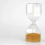 Hourglass with sand flowing, symbolizing the finite limits of human lifespan