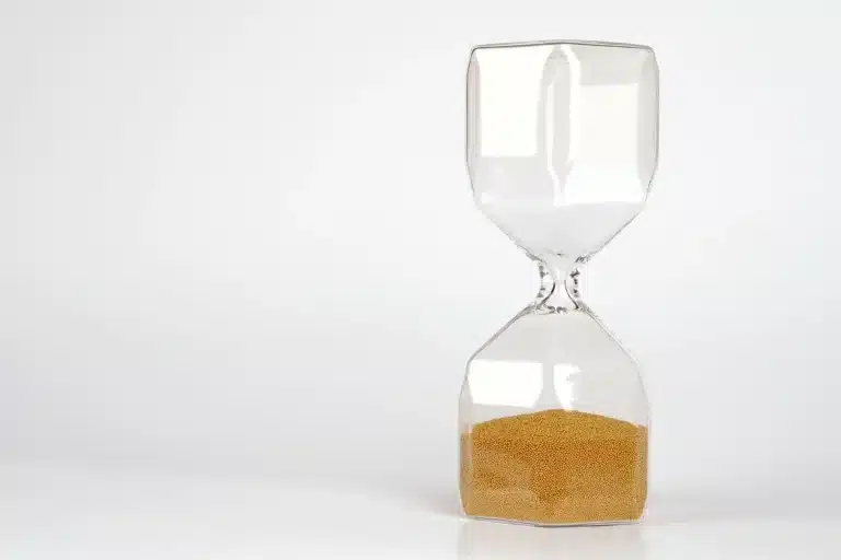 Hourglass with sand flowing, symbolizing the finite limits of human lifespan