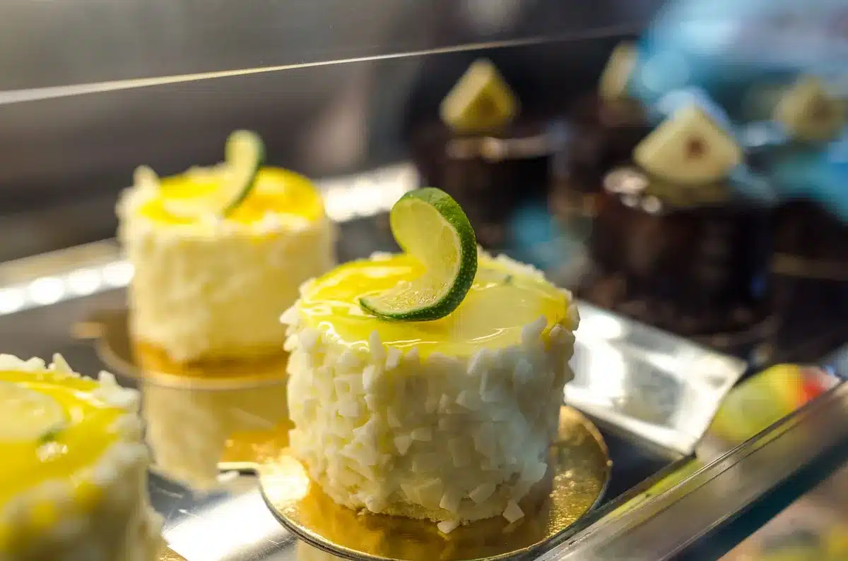 Glossy lemon glaze being poured over a cooled cake loaf