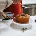 Golden pound cake with glossy lemon glaze cooling on a wire rack in a bright kitchen