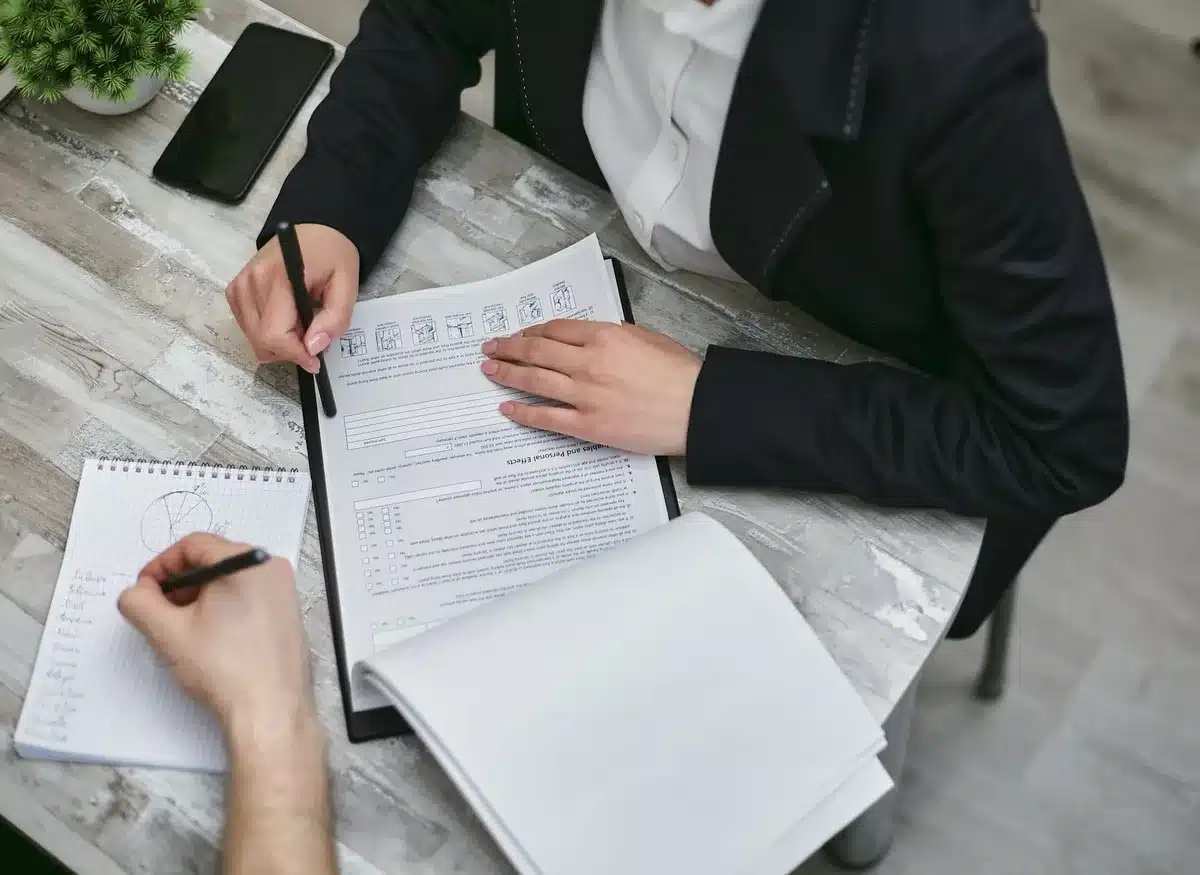 Person reviewing documents and making notes, representing planning for lease changes