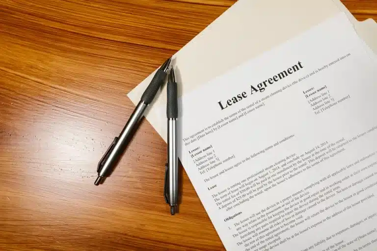 Lease agreement document with pen and calculator on desk, representing new Motability contract terms