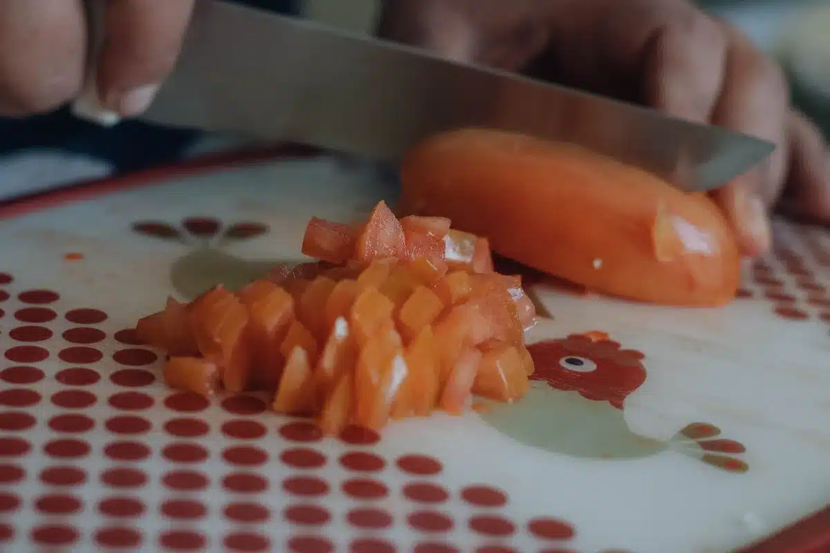 Freshly diced peaches being prepared and drained on paper towels