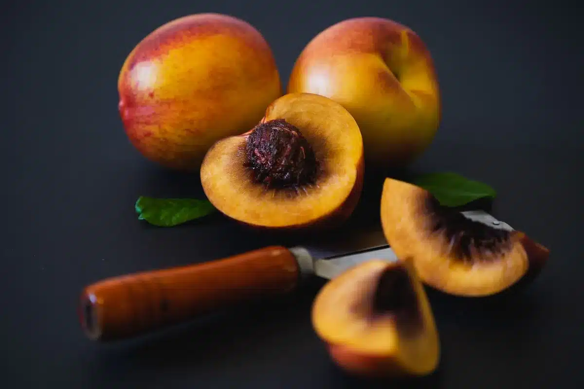 Fresh sliced peaches and baking ingredients for peach crisp filling