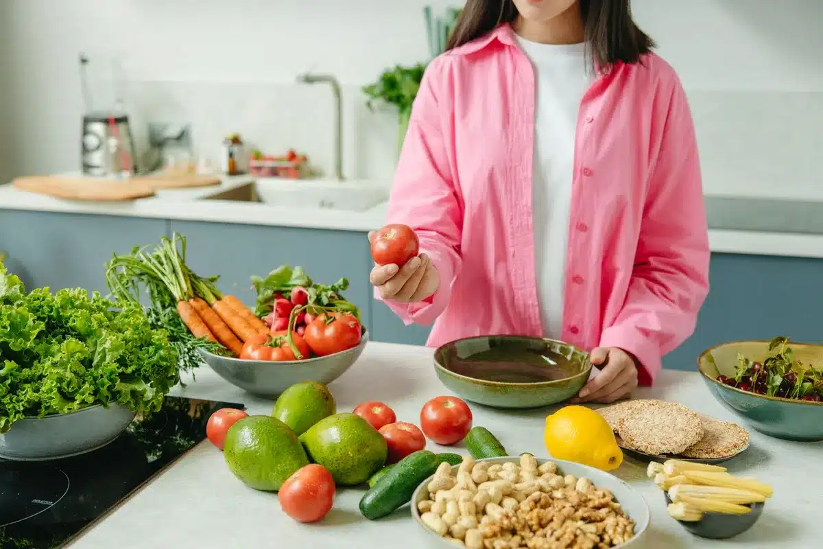 Assortment of whole grains, fresh vegetables and unprocessed ingredients on a kitchen surface