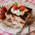Layered strawberry pretzel salad dessert with pretzel crust, cream cheese filling, and strawberry gelatin in a chilled t