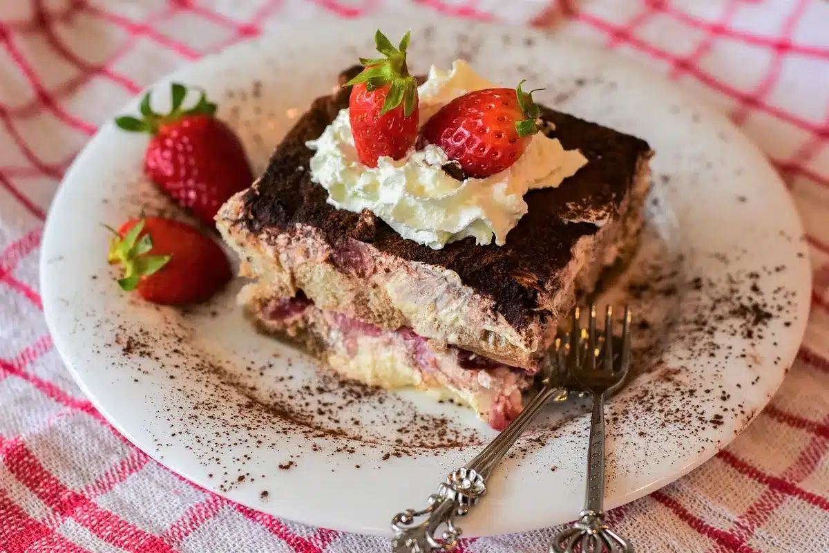 Layered strawberry pretzel salad dessert with pretzel crust, cream cheese filling, and strawberry gelatin in a chilled t