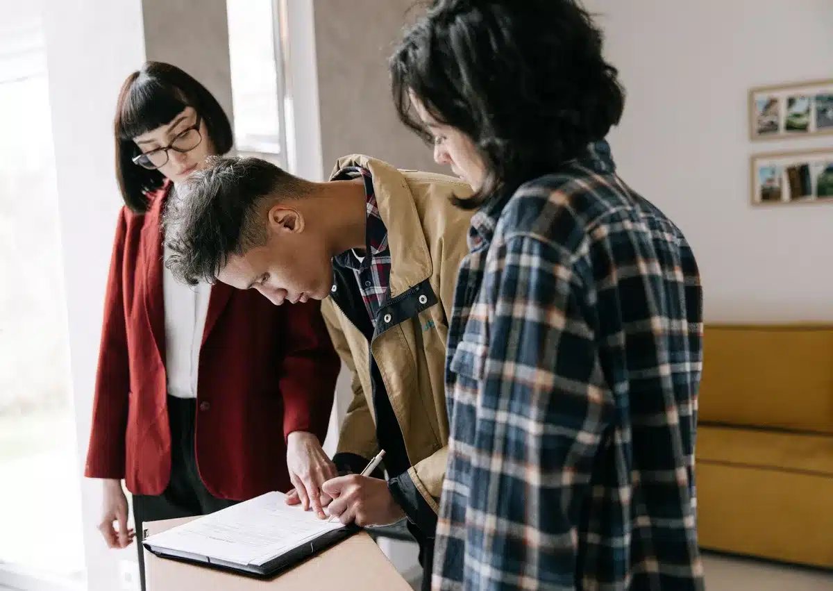 Moving documents and paperwork spread across a desk with a calendar showing summer months