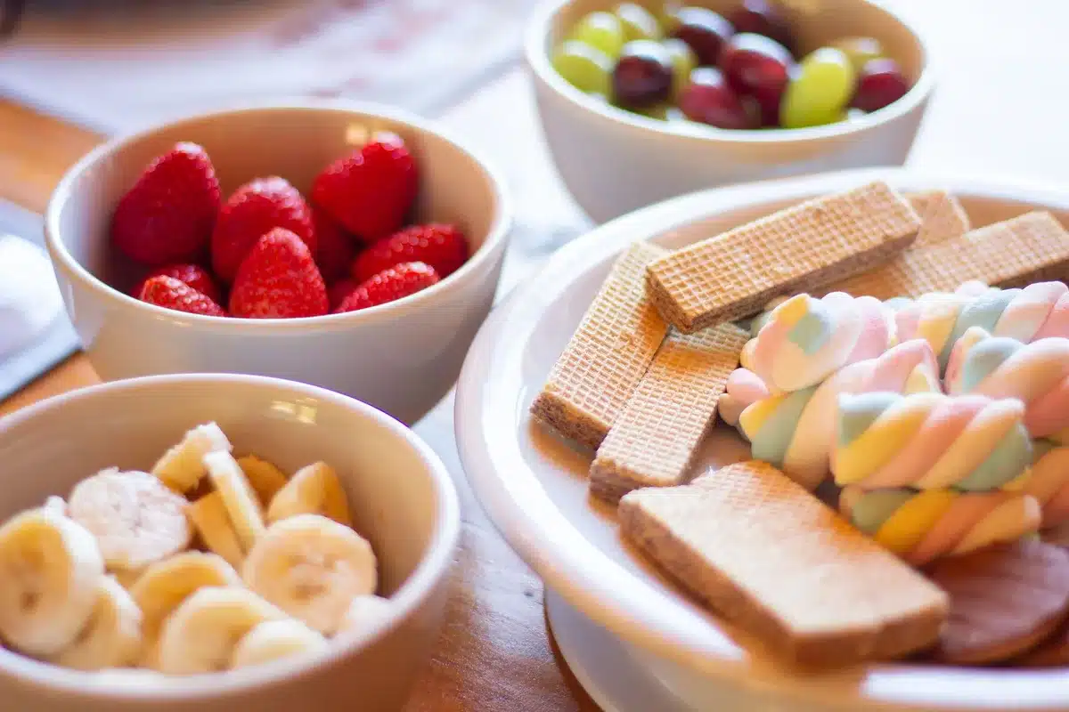 Bright green pistachio pudding salad with marshmallows and nuts in a glass bowl