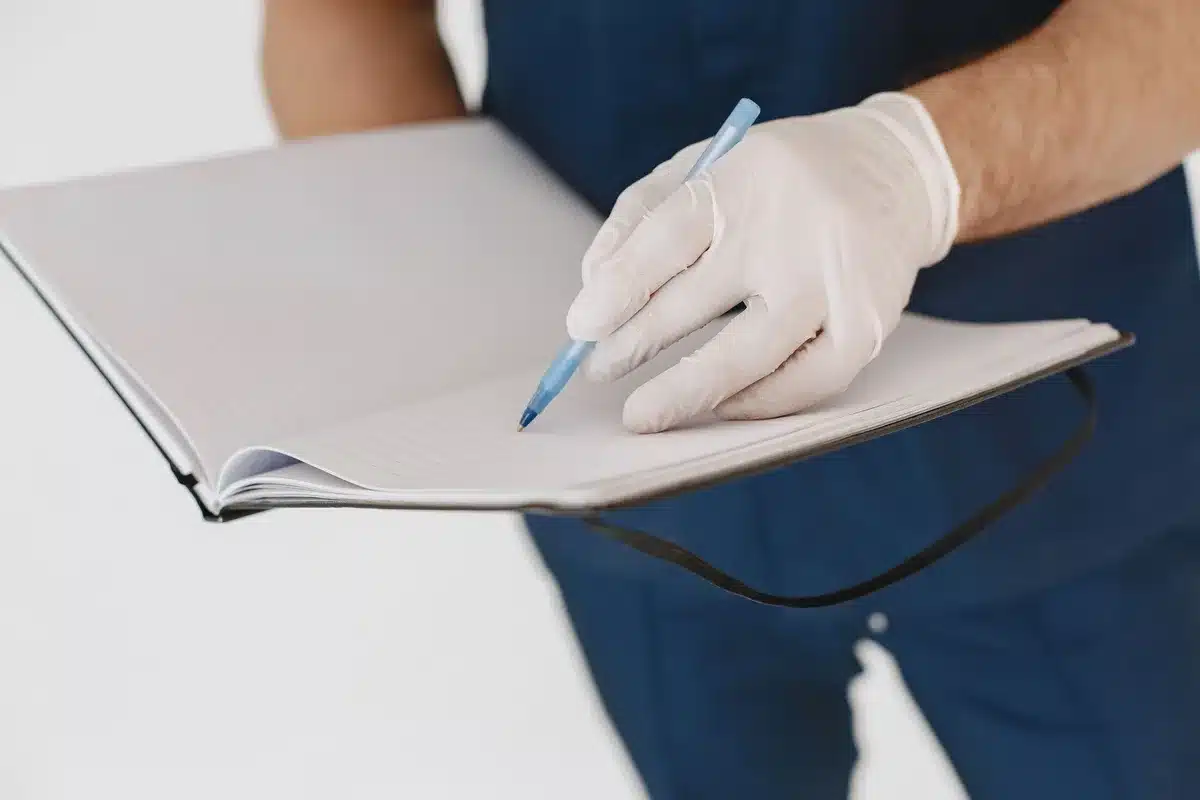 Notebook with handwritten notes documenting symptoms, dates and triggers