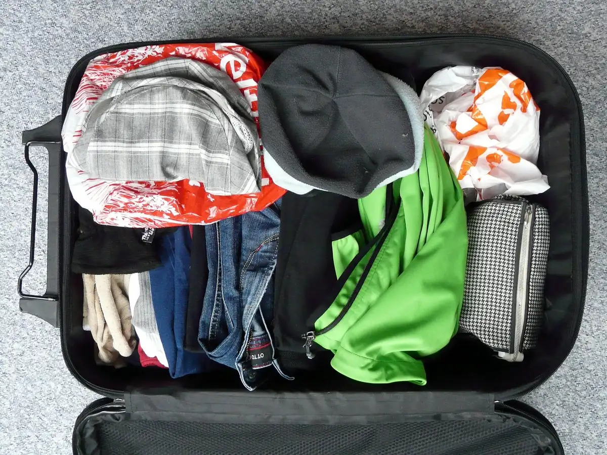 Packing cubes and rolled clothes inside a suitcase for space-saving