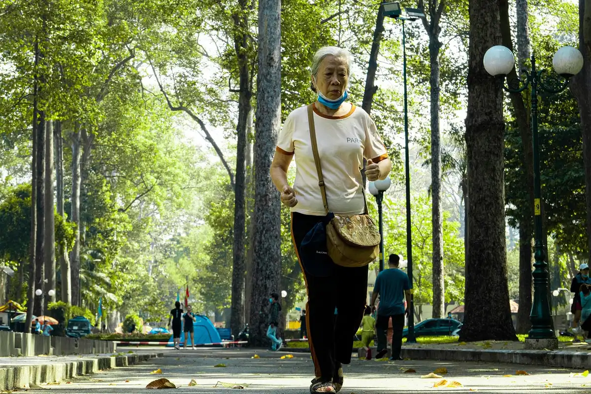 Person jogging with headphones and a notebook, redirecting energy into fitness and creativity