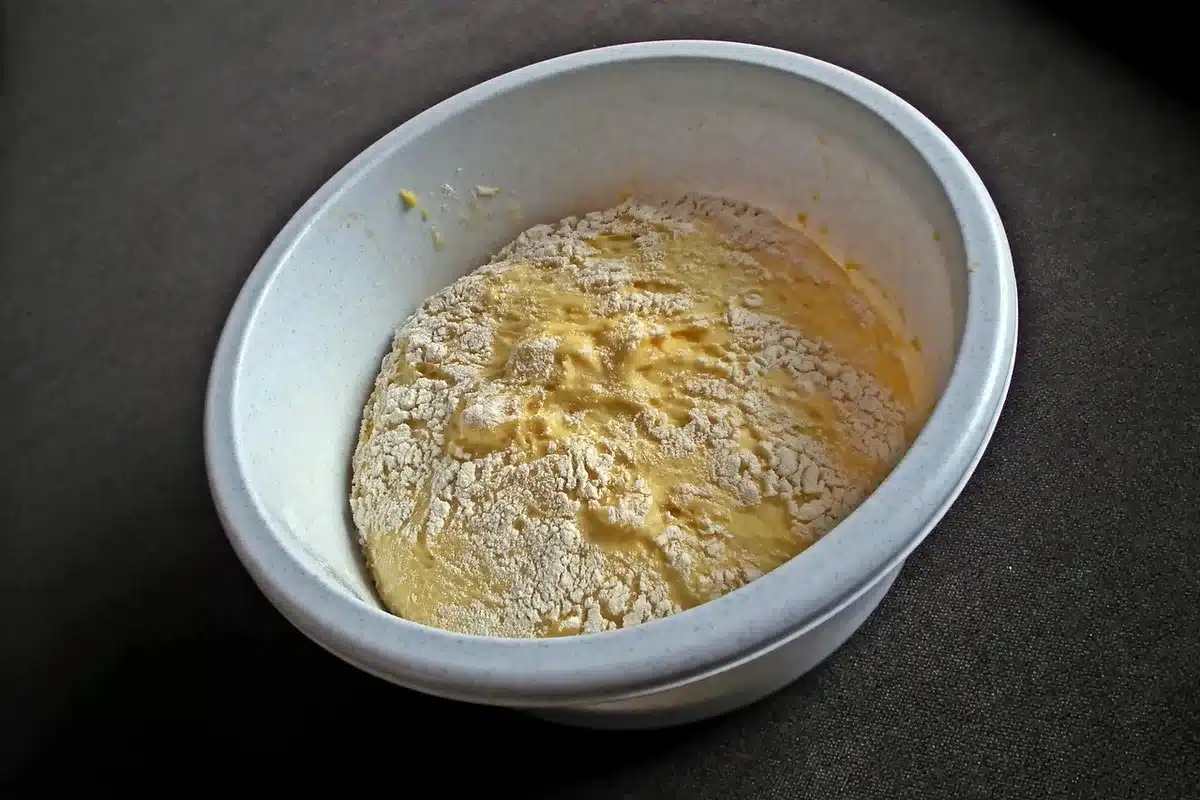 Baking ingredients on a counter including boxed chocolate cake mix, eggs and milk
