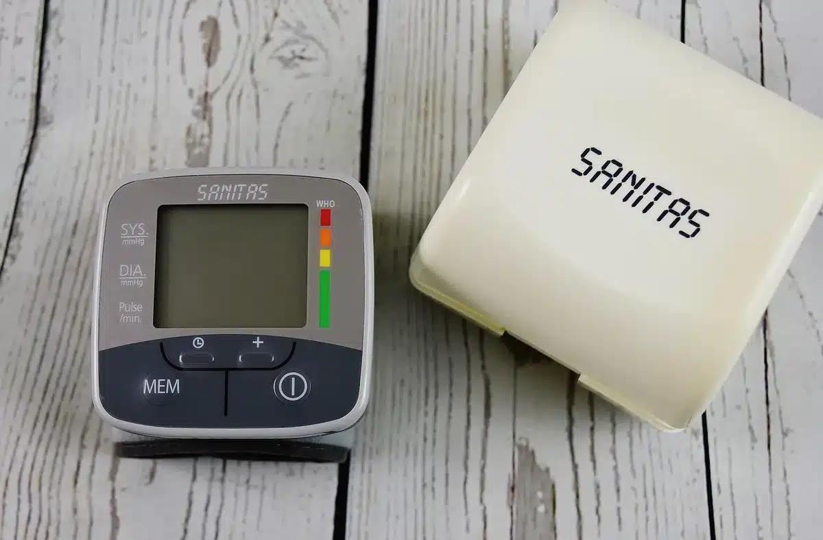 Collection of remote monitoring devices: ECG patch, blood pressure cuff, weight scale, and pulse oximeter used in home h