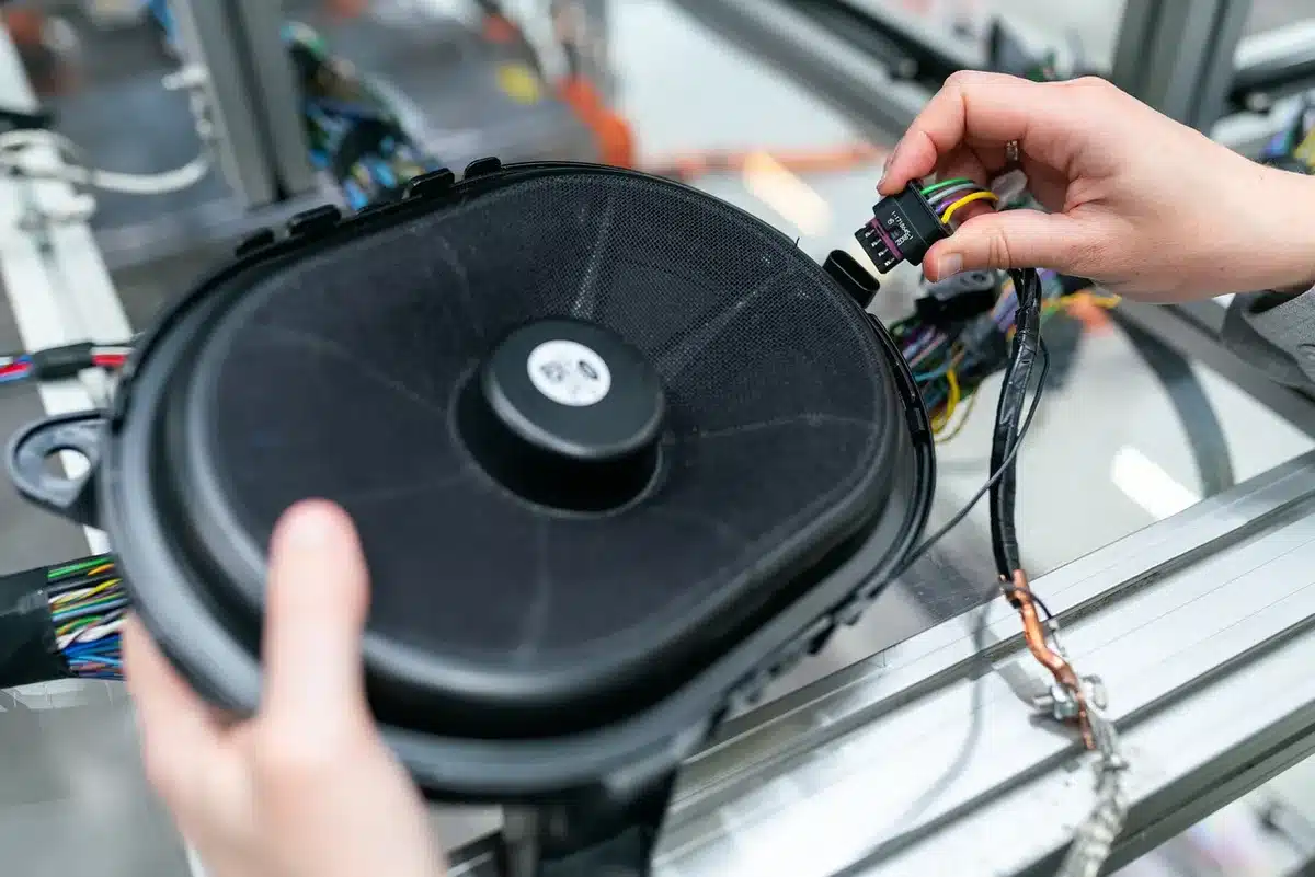 Engineers inspecting electric powertrain components in a workshop