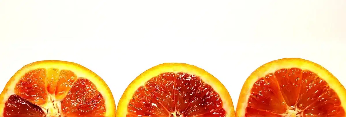 Fresh navel and blood oranges with zest on a kitchen counter