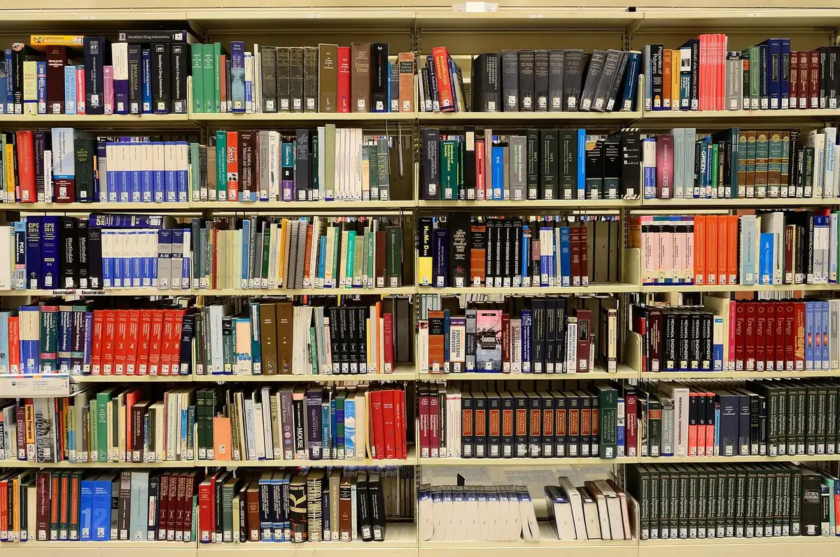 Stacked research papers and charts on a desk illustrating meta-analysis findings