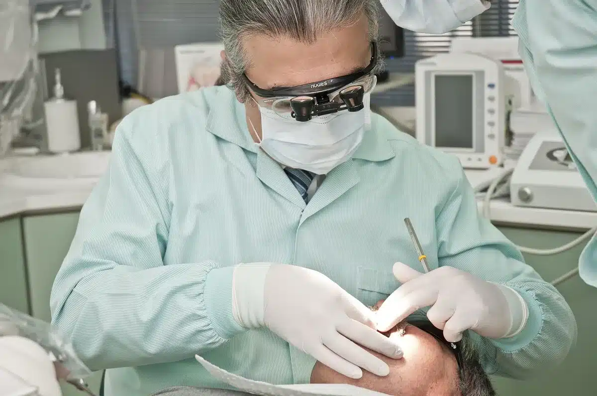 Person organizing medical documents and family health history information for a doctor's appointment.