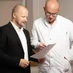 Doctor and patient reviewing medical documents and discussing treatment options during a consultation.