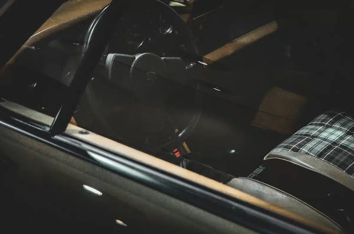 Interior car door with a small warning sticker near the handle