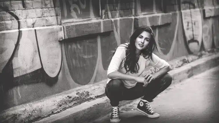 Person wearing wide-leg jeans styled with a tucked top and ankle boots, demonstrating flattering proportions.