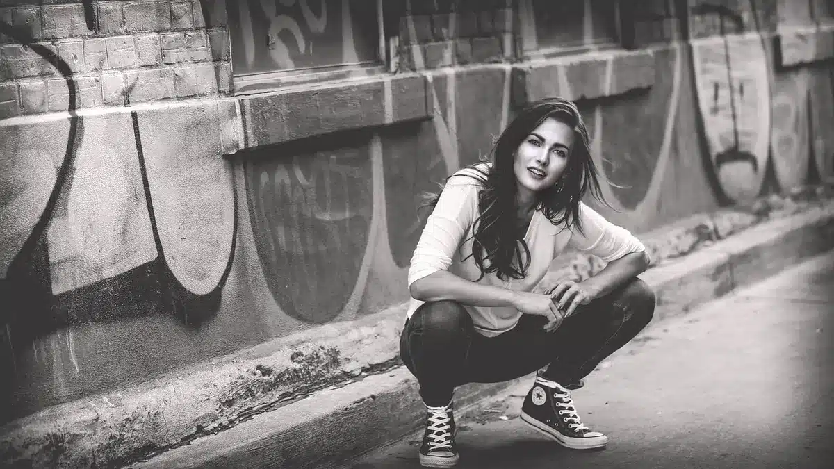 Person wearing wide-leg jeans styled with a tucked top and ankle boots, demonstrating flattering proportions.