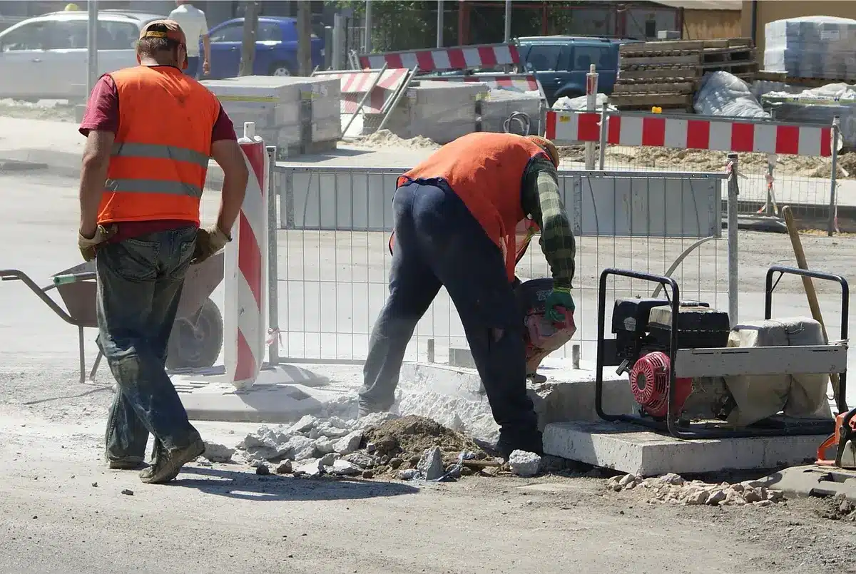 Temporary roadside fencing being installed alongside a carriageway