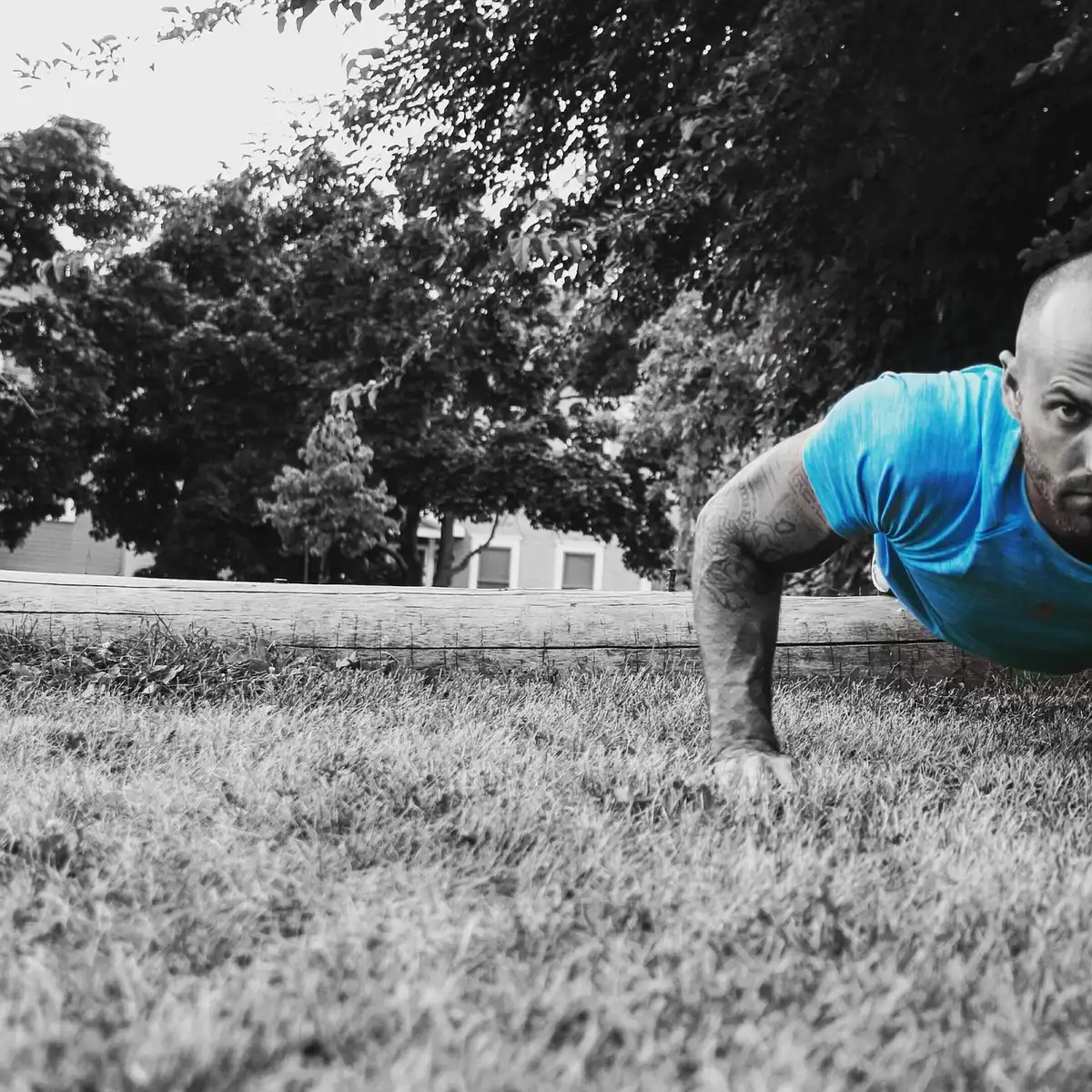 Person's hands on knees during a short home bodyweight workout, midday light