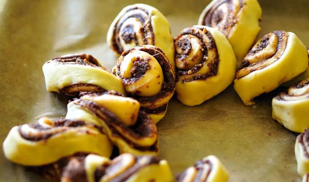 Two bowls showing dark chocolate batter and lighter honey-sweet batter