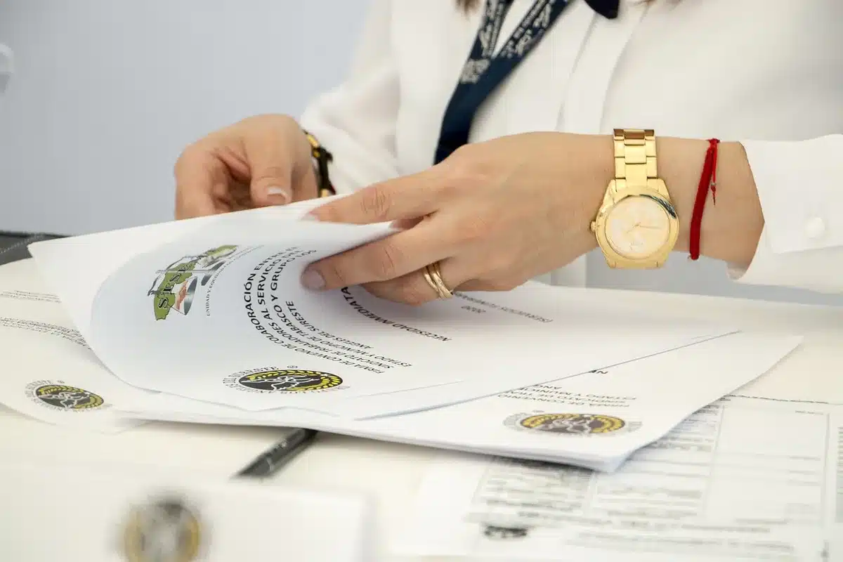 Pile of car finance contracts on a bright office table