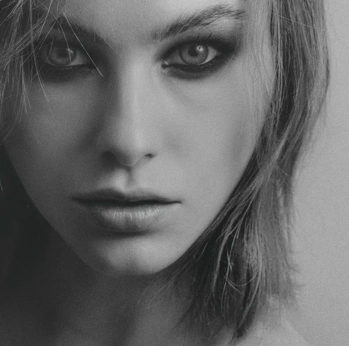Model with voluminous beehive hairstyle and dramatic makeup